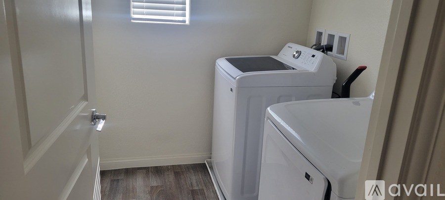 A small laundry room with a washer and dryer.