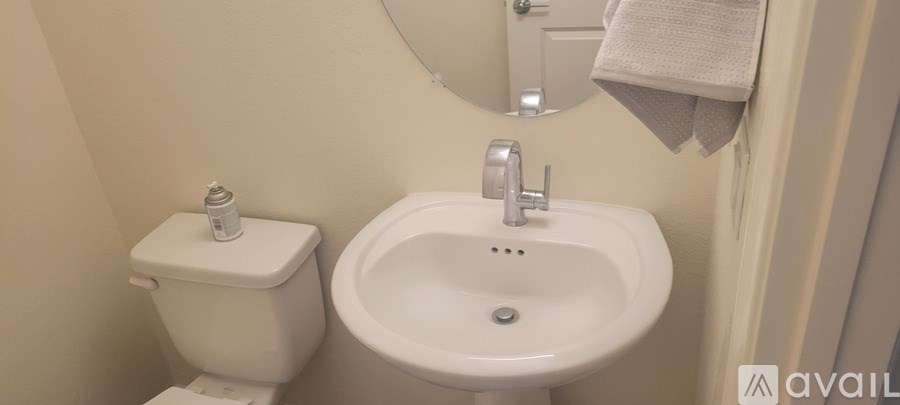 A white toilet and sink in a bathroom.