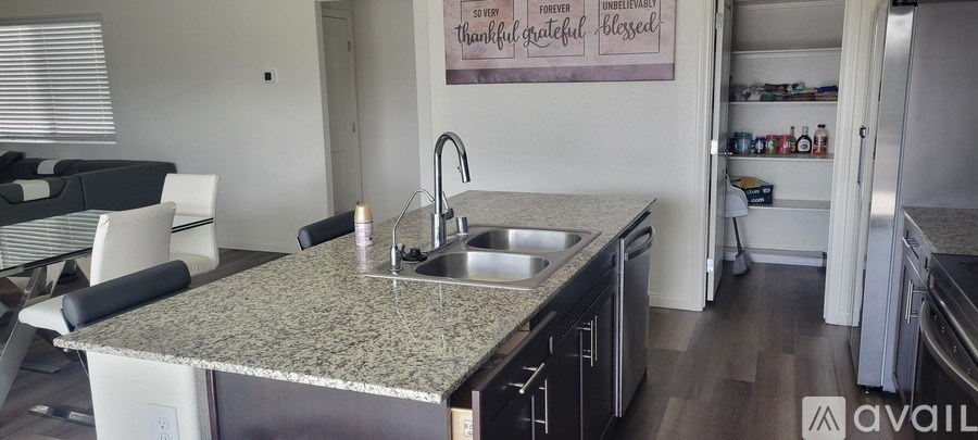 A kitchen with granite countertops and a sink.