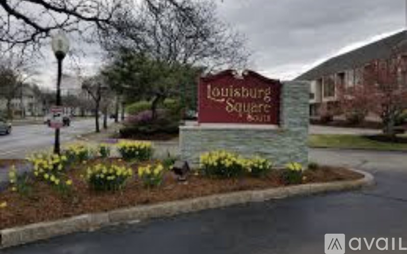 A sign for Louisburg Square is in front of a building.