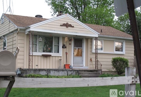 A house with a white door and a small porch.