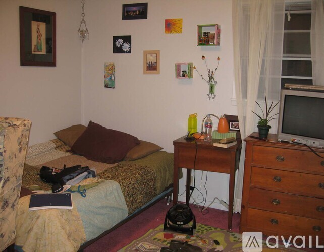 A bedroom with a bed, desk, and chair.