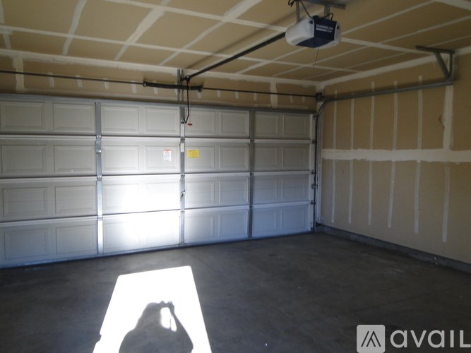 Garage with a white ceiling and a white light.