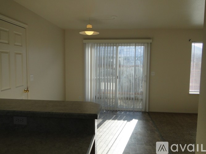 A room with a marble countertop and a sliding glass door.