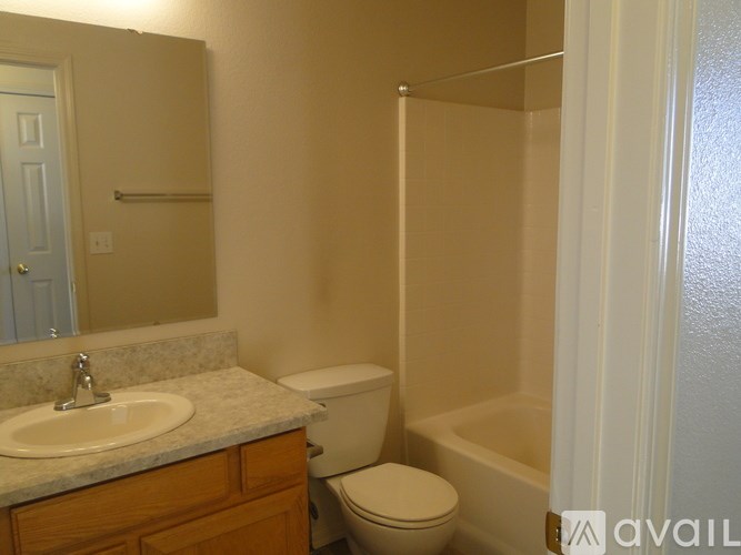 A bathroom with a toilet, sink, and bathtub.