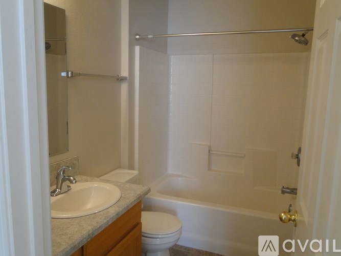 A bathroom with a toilet, sink, and bathtub.