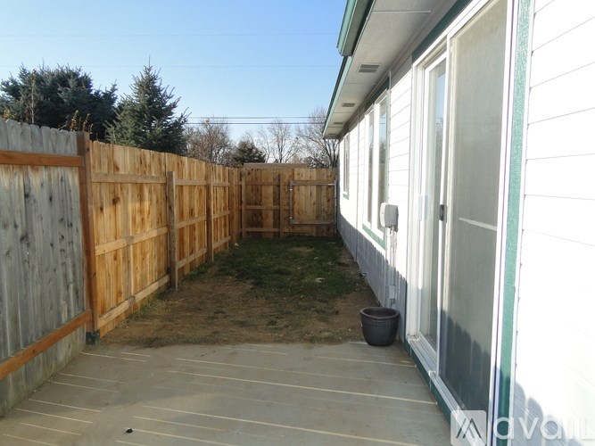 A backyard with a wooden fence and a shed.