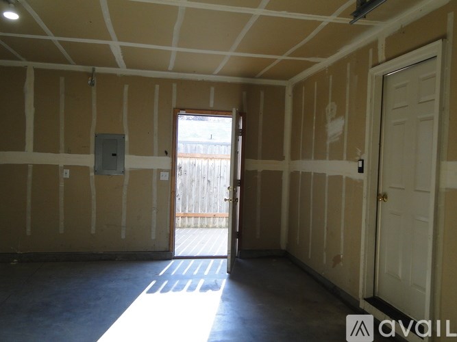 A room with a door and a window is available for rent.