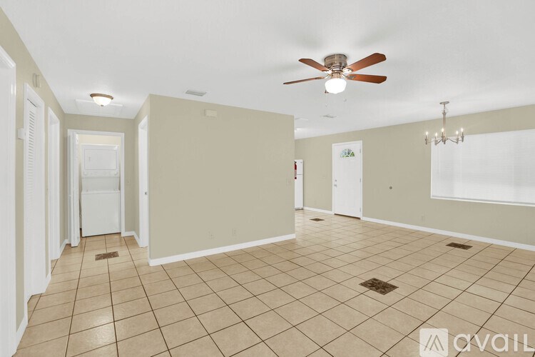 A room with a ceiling fan and tiled flooring.