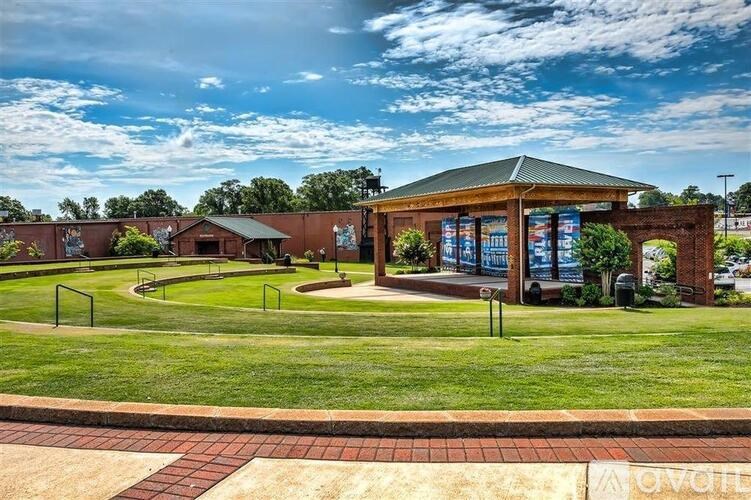 A building with a green roof and a sign that says "AOVIE" in front of it.