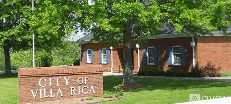 A sign that says "City of Villa Rica" in front of a building.