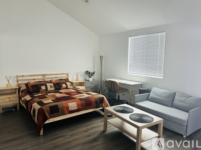 A small white house with a black door and window.