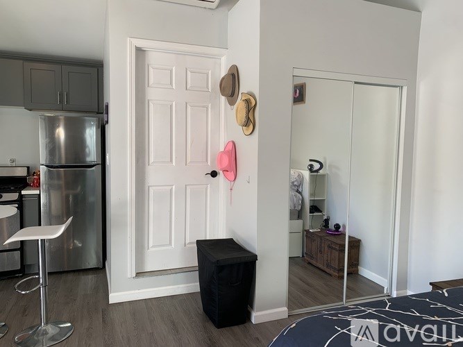 A white door with a black box below it and a pink object to the left of the door.