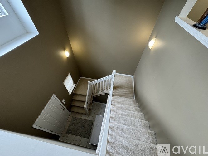 A staircase with a carpeted runner and white risers.