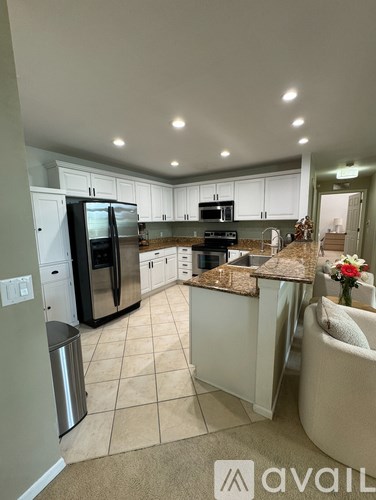 A kitchen with granite countertops and stainless steel appliances.
