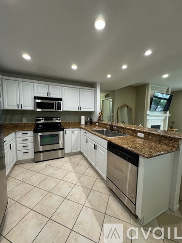 A kitchen with granite countertops and stainless steel appliances.