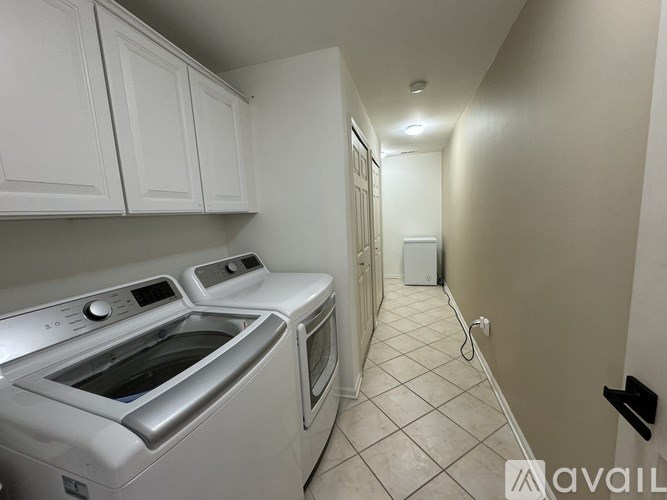 A kitchen with white cabinets and a stainless steel dishwasher.