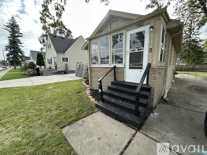 A house with a front yard and a porch.
