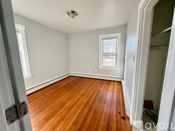 A room with wooden floors and a window.