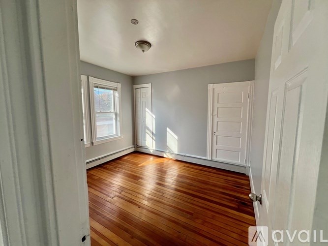 A room with wooden floors and white walls.