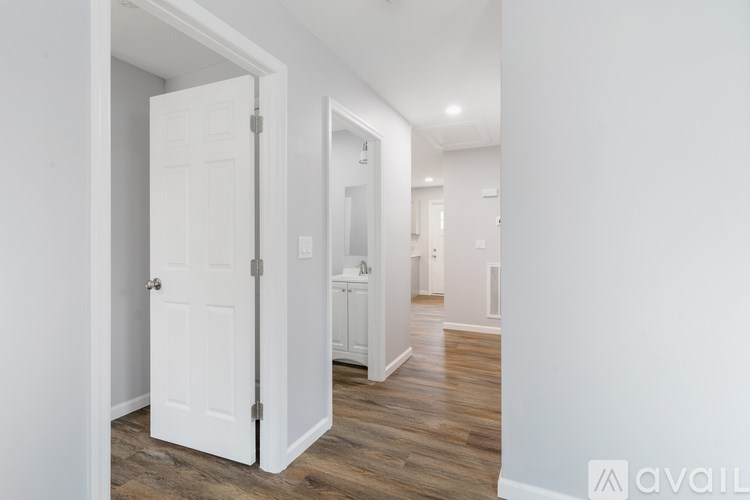 A white door is open to a hallway.