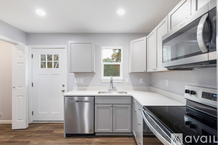 A kitchen with white cabinets and stainless steel appliances.