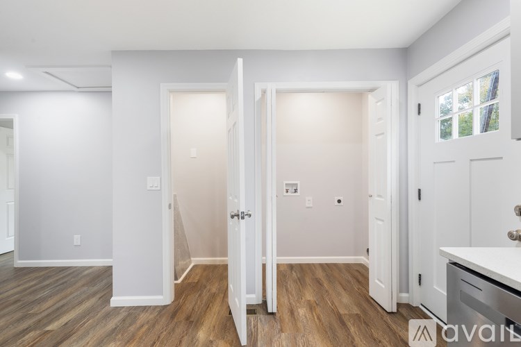 A room with a white door and a window.