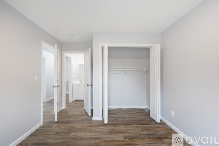 A room with a white door and a white wardrobe.