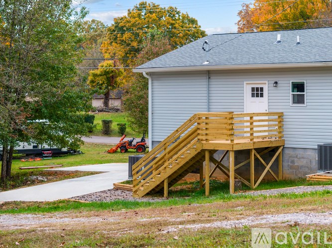 A house with a wooden staircase leading to the front door.