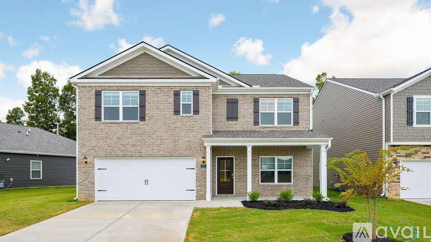 A two-story house with a garage is for sale.