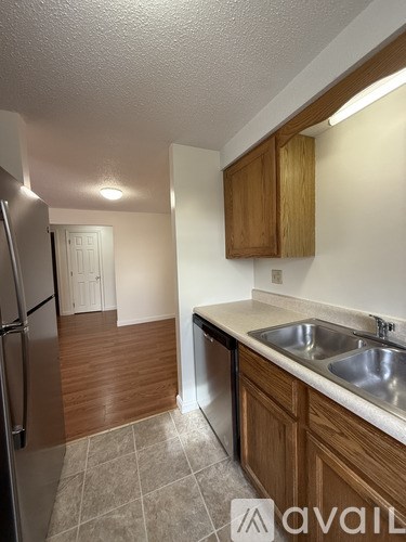 A white door is open to a room with a carpeted floor.