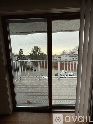 A white car is parked on a driveway.