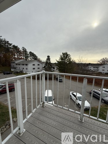 A white door is open to a room with a grey carpet.