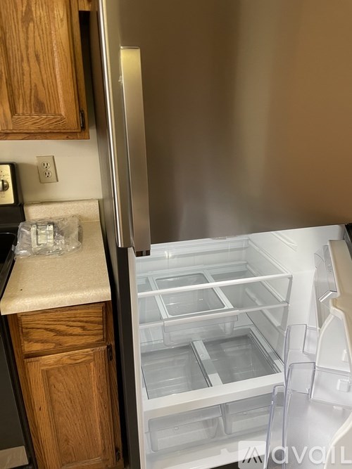 A room with a carpeted floor and a ceiling light fixture.