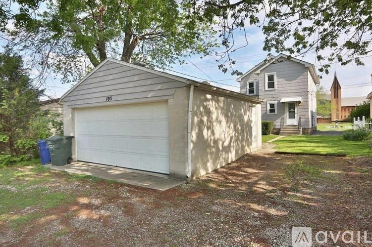 A house with a garage is for sale.