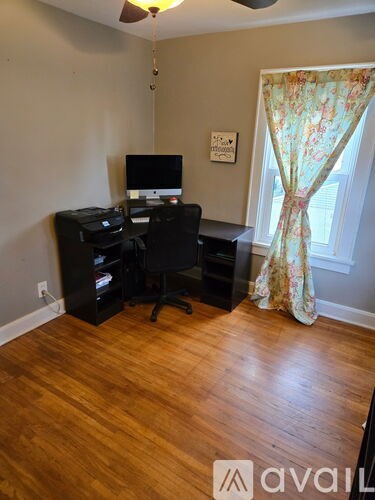 A room with a desk and a computer monitor.