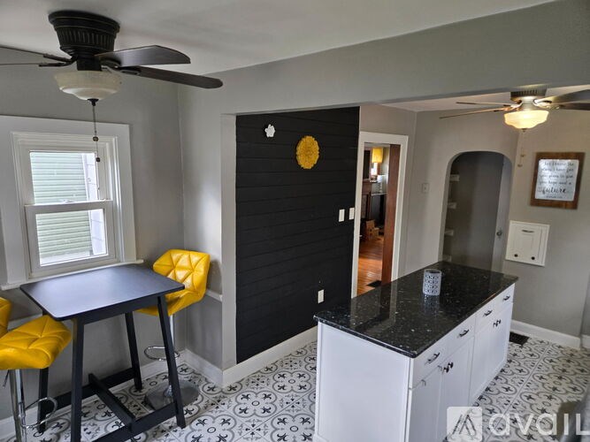A kitchen with a black and white tiled floor.