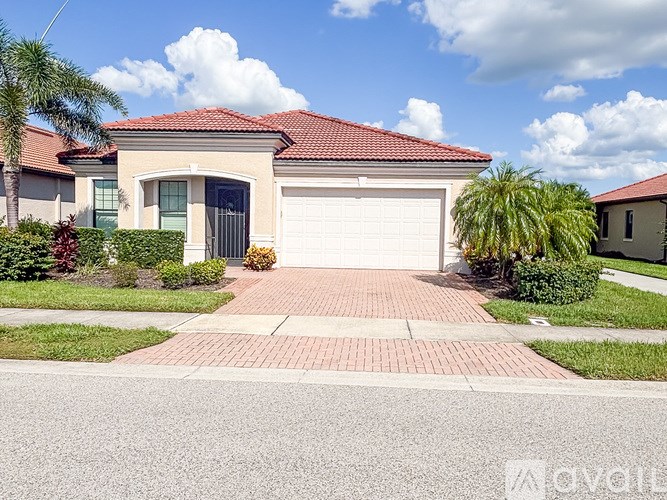 A house with a red tiled roof and a garage door.