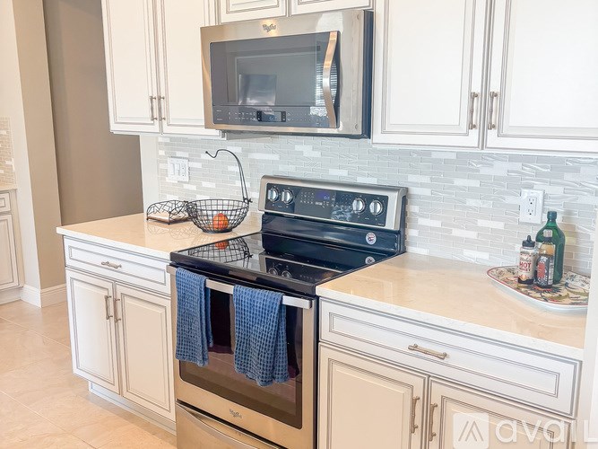 A kitchen with a stove top oven and a microwave above it.