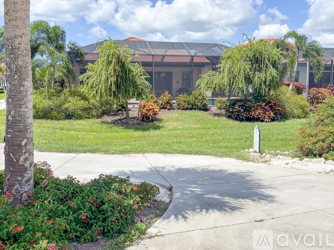 A well-maintained garden in front of a building with a clear sky above.
