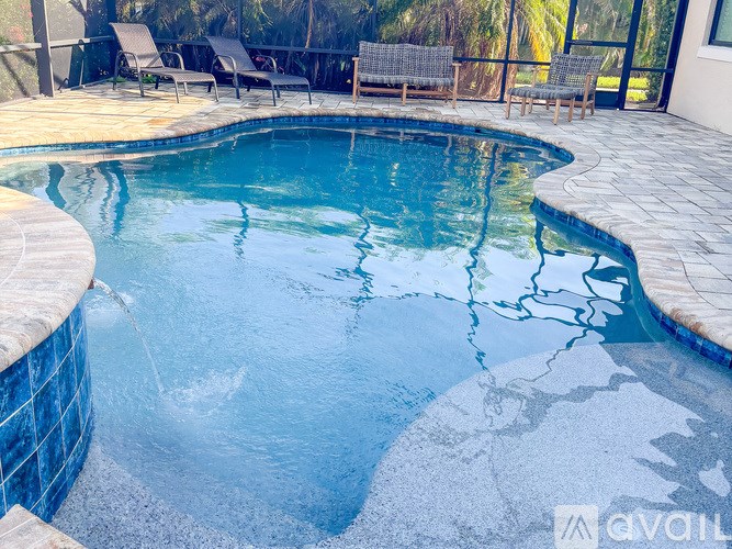 A pool with a waterfall feature in the middle.