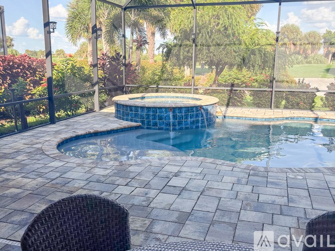 A round pool with a black fence around it.