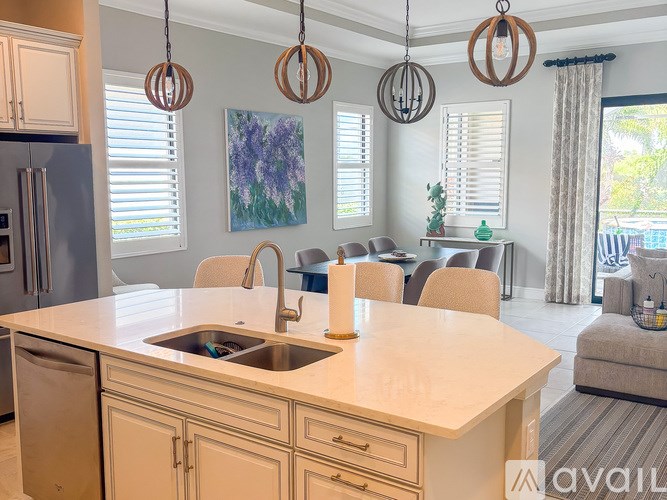 A kitchen with a sink and a refrigerator.