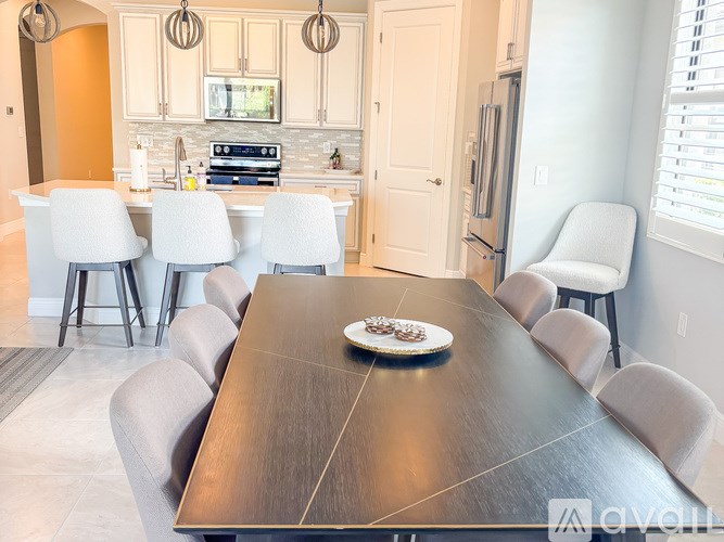 A modern kitchen with a dining table set for six.