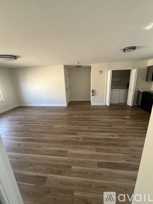 A room with wooden flooring and a white ceiling.