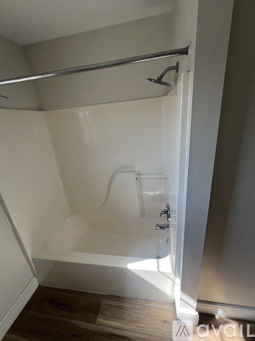 A white door with a silver handle is open.