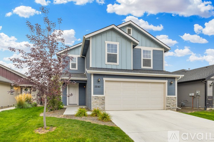 A house with a blue garage door is for sale.