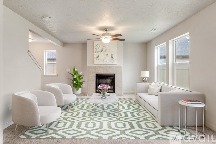 A living room with a fireplace and a green and white rug.