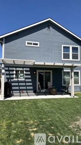 A house with a blue exterior and a covered patio area.