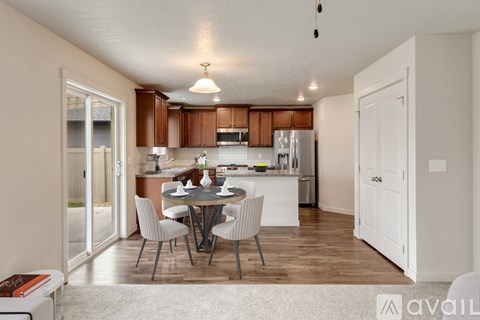A kitchen with a table and chairs in the middle of the room.
